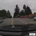 Couple fighting at intersection near black sedan