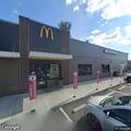 Person slumped over in blue Subaru at McDonald's