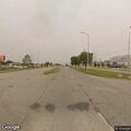 Truck driving with open cargo door on US-2