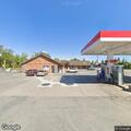 Person experiencing chest discomfort at gas station