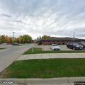 Person with severe back pain at Warroad clinic parking lot