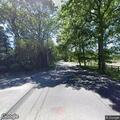 Driver flees after car crash into woods in Manorville