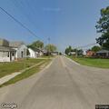 Man dismantling camper in middle of Freelandville road