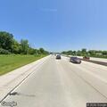 Car hits retaining wall at highway roundabout