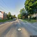 Man lying in road at West Main St and Washington Ave