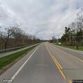 Truck spill leaves debris on roadway near tracks