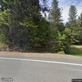 Vehicle hits power pole and rolls into trees