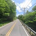 Person in wheelchair riding in middle of roadway