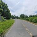 Woman walking on route 142 with cat in bad weather