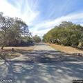 Tree partially blocking road near landscaping company