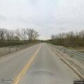 Suspicious person takes item from truck near bridge