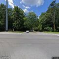 Stalled red Lexus in turning lane at intersection