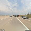 Car with flat tire on highway shoulder