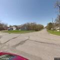 Dog left tied to fence near roadway