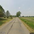 Tree limb resting on power lines in Noble County