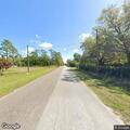 Tree blocking road and touching power lines