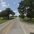 Train blocking highway and farm road in Dime Box