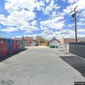 Person lying in street wearing safety vest in Reno