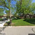 Fallen tree blocks driveway and street in Leawood