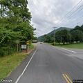 Car stopped in roadway with flashing lights