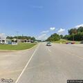 Person experiencing chest pain at highway business location