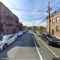 Homeless man sleeping on sidewalk at Bronx Park East