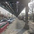 Woman lying on paid-area bench at subway station