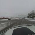Woman with stroller walking on roadway at Simmons and Fremont