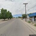 Officer assists motorist in gray sedan