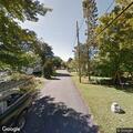 Older man in distress riding bike on Maple Street