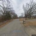 Car crashes through fence and rests against trees