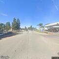 Officer checks person behind market
