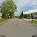 Man looking into vehicles near Sure Ministries