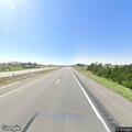 Officer checks red truck stopped along interstate
