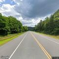 Car hits tree on Route 2, report of gun at scene