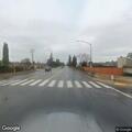 Person walking in and out of traffic near gas station