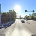 Person in dark sleeping bag on Foothill Blvd roadway