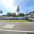 Adult male sleeping behind business near Palm Harbor
