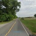Resident sits with loose animal on Industry Road