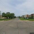Hole in pavement near sewer grate reported