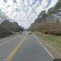 Man walking in road and kicking sticks on Gilead Rd