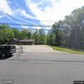 Low hanging wire and tree hazard in roadway