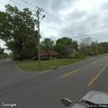 Man hitting fence with tool near shopping center