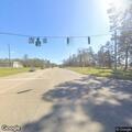 Person lying on roadway at highway intersection