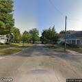Confused female with head pain at intersection in Ludington