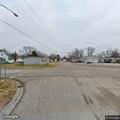Officer checks person in alley near railroad tracks