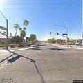 Elderly woman in wheelchair with elderly man at intersection