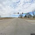 Wind-damaged yield sign at highway intersection