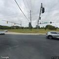 Person riding on hood of moving car in Clinton