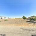 Person laying on roadside waving phone flashlight in Firebaugh
